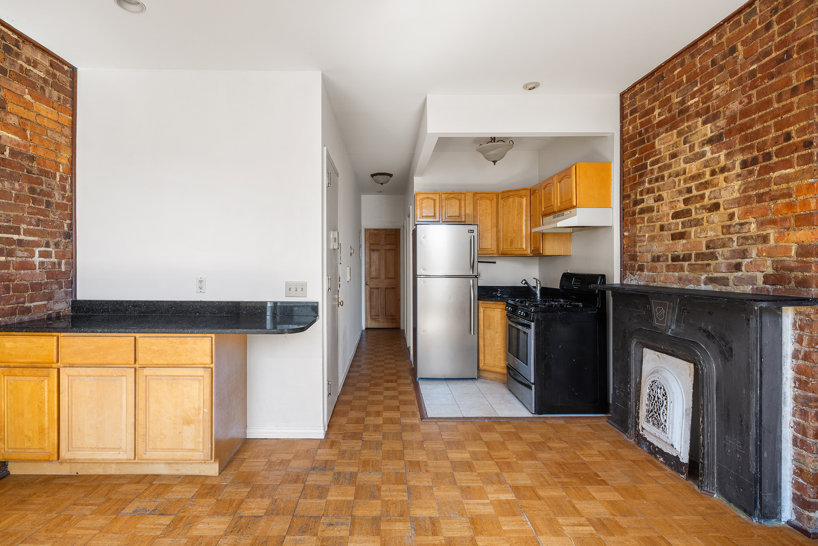 37 Quincy Street Brooklyn, NY 11238 - Photo 14 of 24 a kitchen with stainless steel appliances granite countertop a refrigerator a stove and a sink with large window