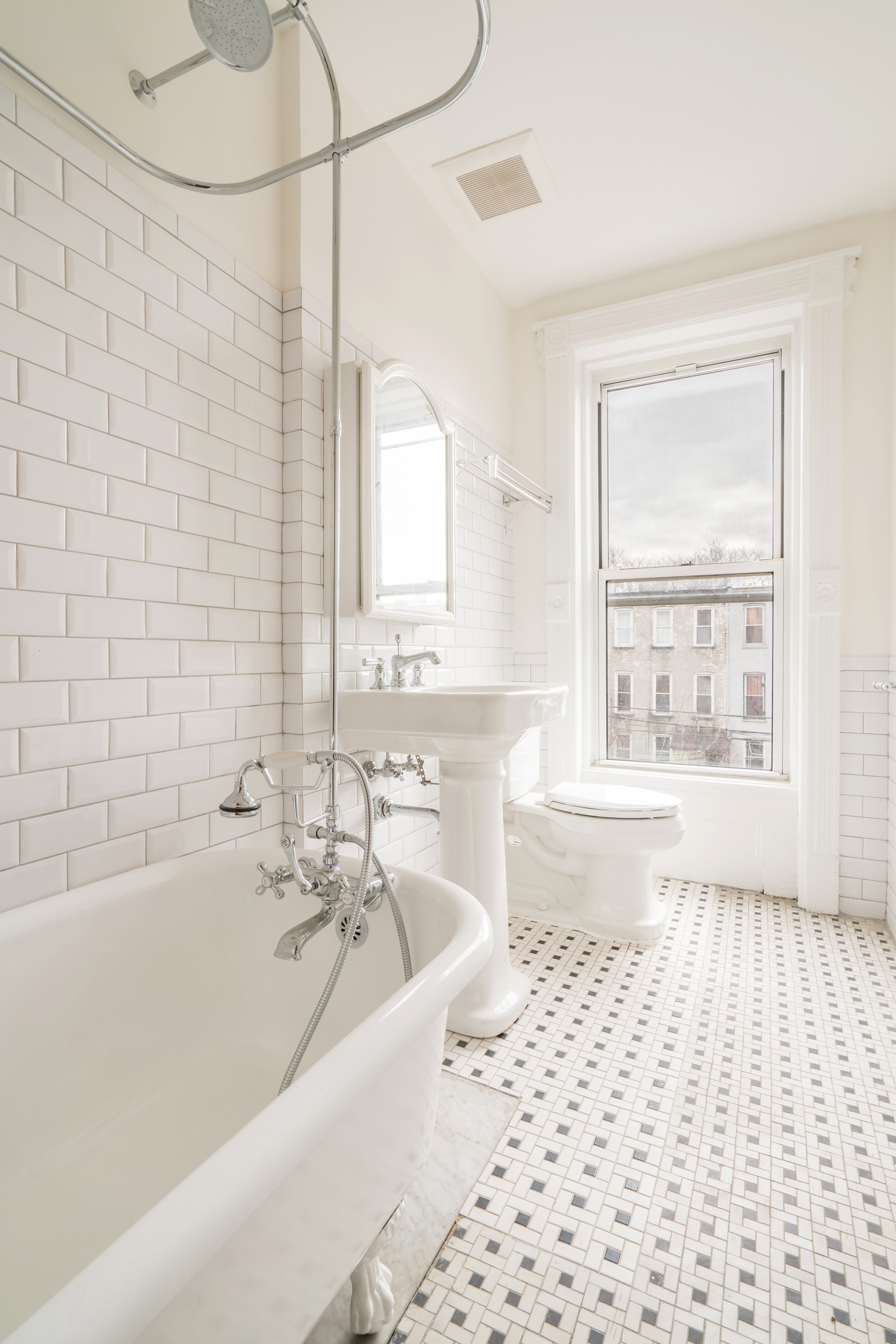 670 Macon Street, Unit 2 Brooklyn, NY 11233 - Photo 12 of 16 a bathroom with a bathtub and next to a window