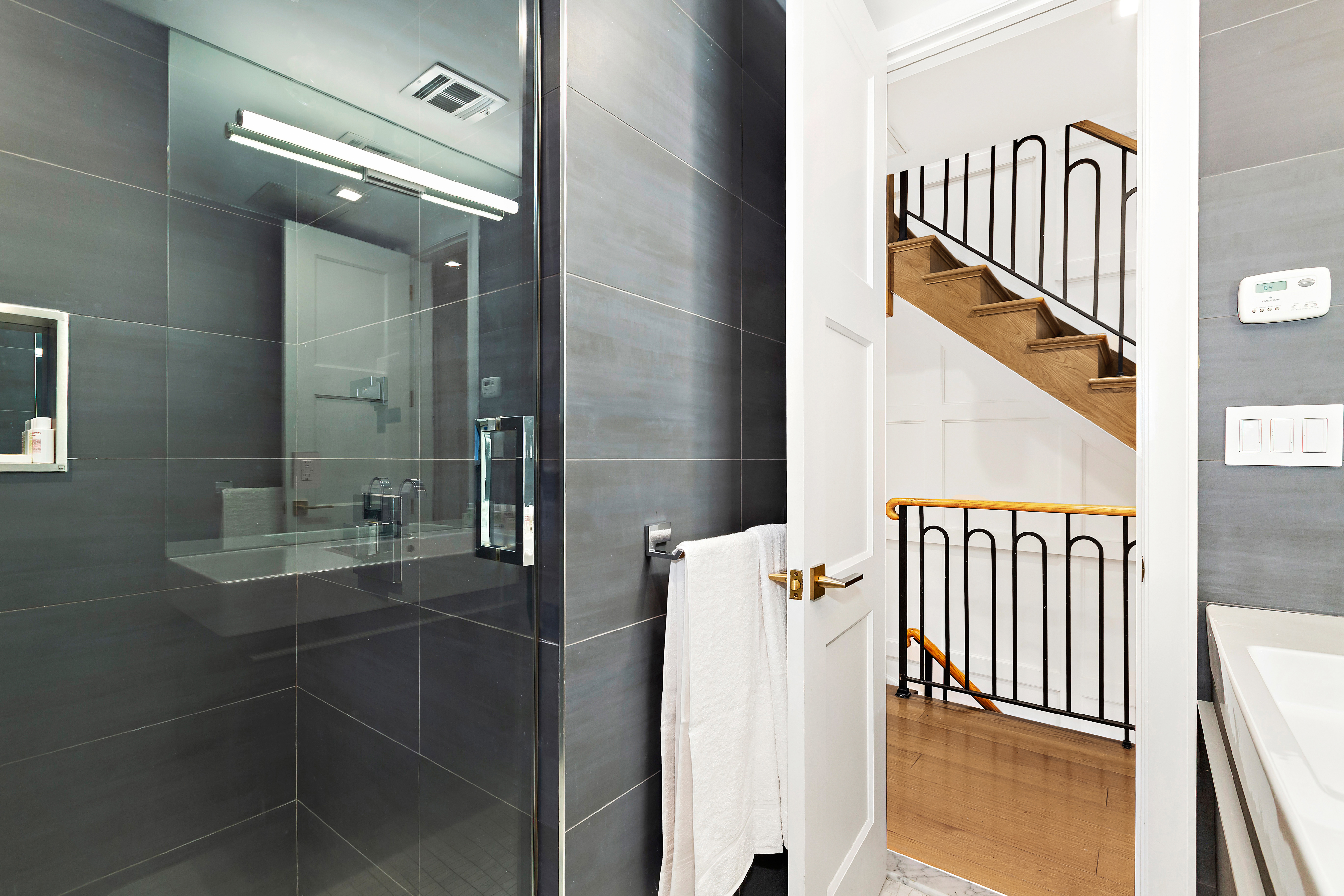 134 East 36th Street Manhattan, NY 10016 - Photo 20 of 28 a bathroom with a sink and mirror