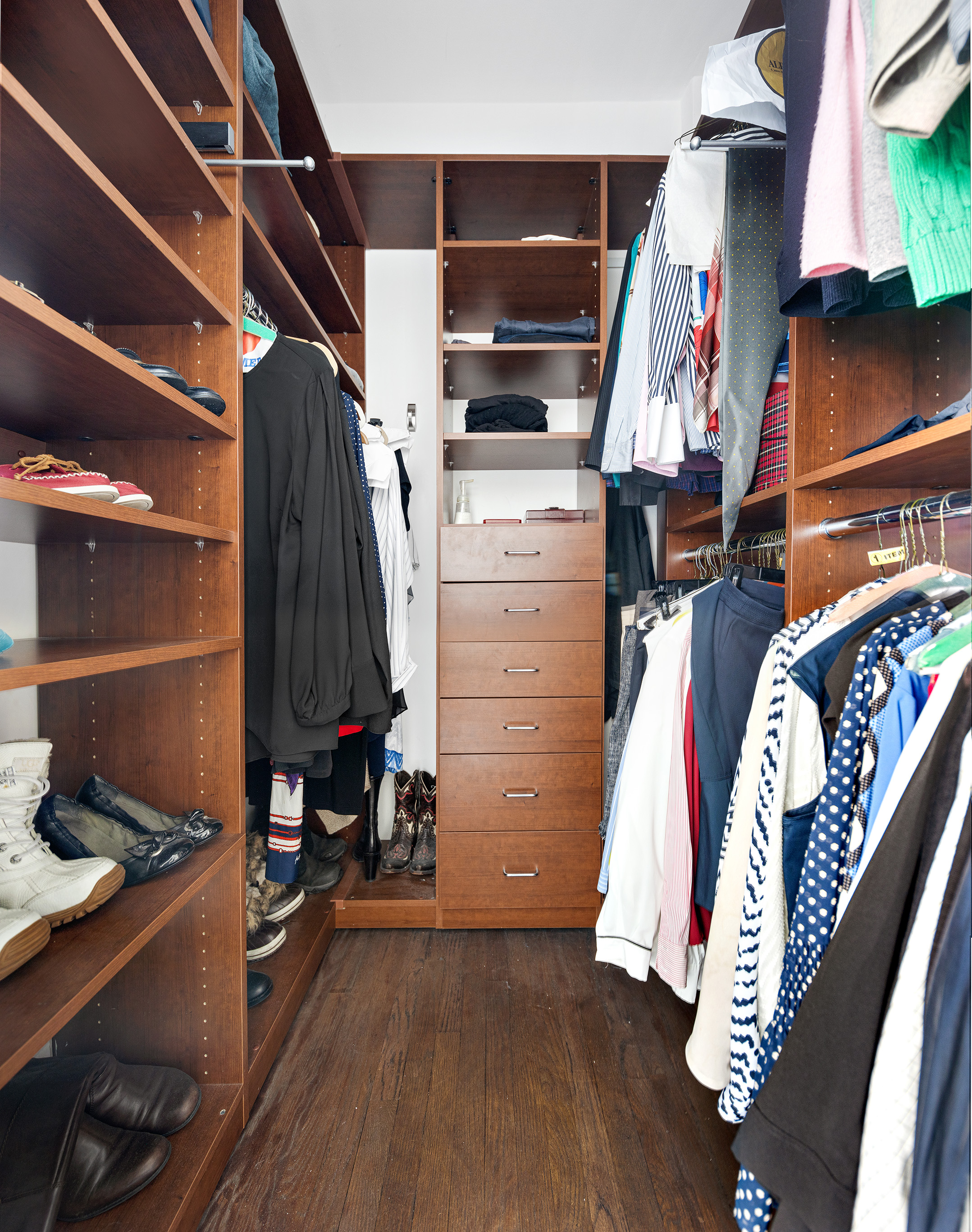 230 East 50th Street, Unit 9C Manhattan, NY 10022 - Photo 4 of 9 a view of walk in closet with clothes and shoes