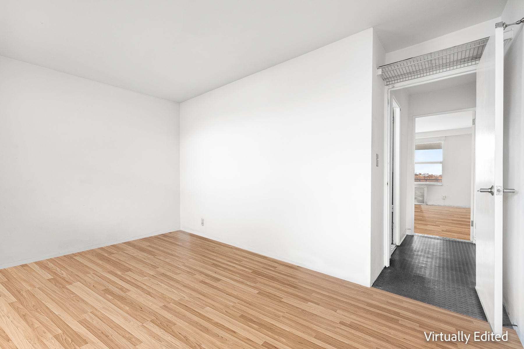 35-50 85th Street, Unit 9J Queens, NY 11372 - Photo 7 of 11 a view of a room with wooden floor and a bathroom