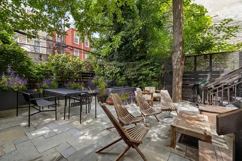 a view of backyard with sitting area