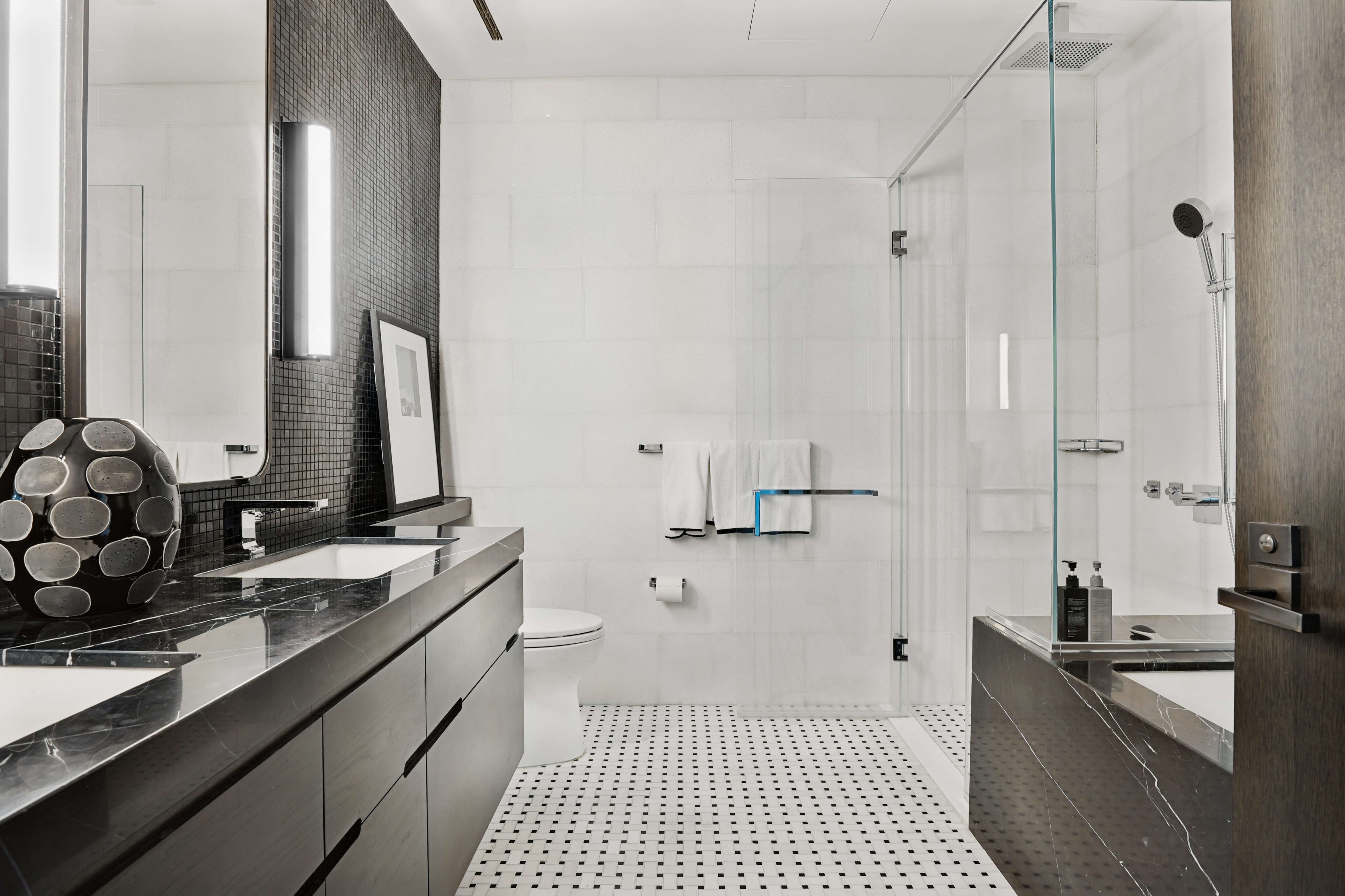 172 Madison Avenue, Unit 24B Manhattan, NY 10016 - Photo 8 of 16 a bathroom with a double vanity sink a mirror and a shower