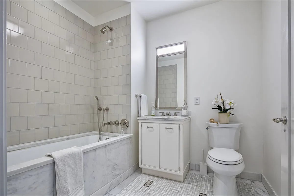 160 West 12th Street, Unit 78 Manhattan, NY 10011 - Photo 13 of 22 a bathroom with a toilet sink and bathtub