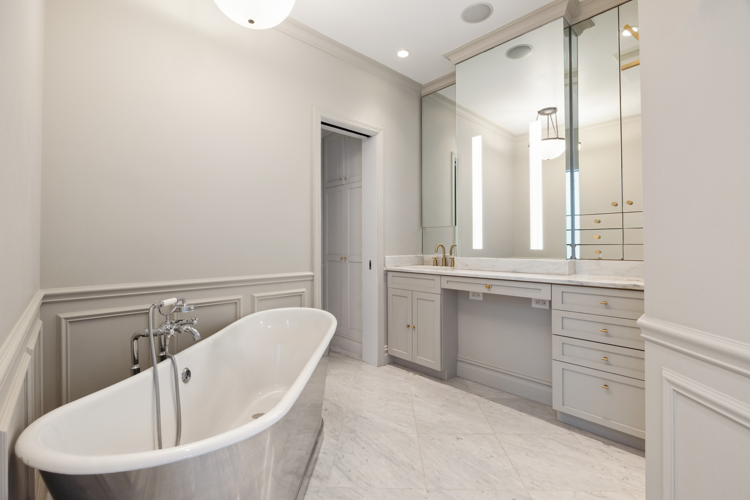 250 Mercer Street, Unit A504 Manhattan, NY 10012 - Photo 7 of 13 a bathroom with a bathtub sink and mirror
