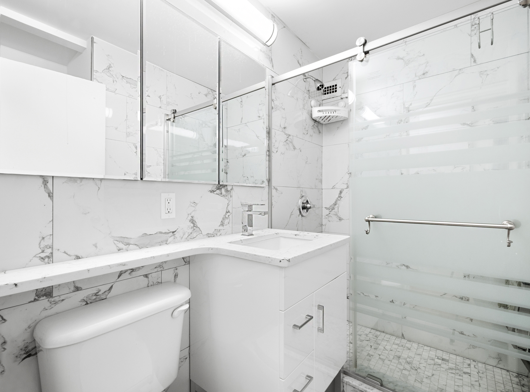 555 Main Street, Unit 1114 Manhattan, NY 10044 - Photo 6 of 9 a utility room with a sink a toilet and vanity