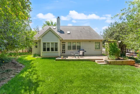 a front view of a house with swimming pool having outdoor seating