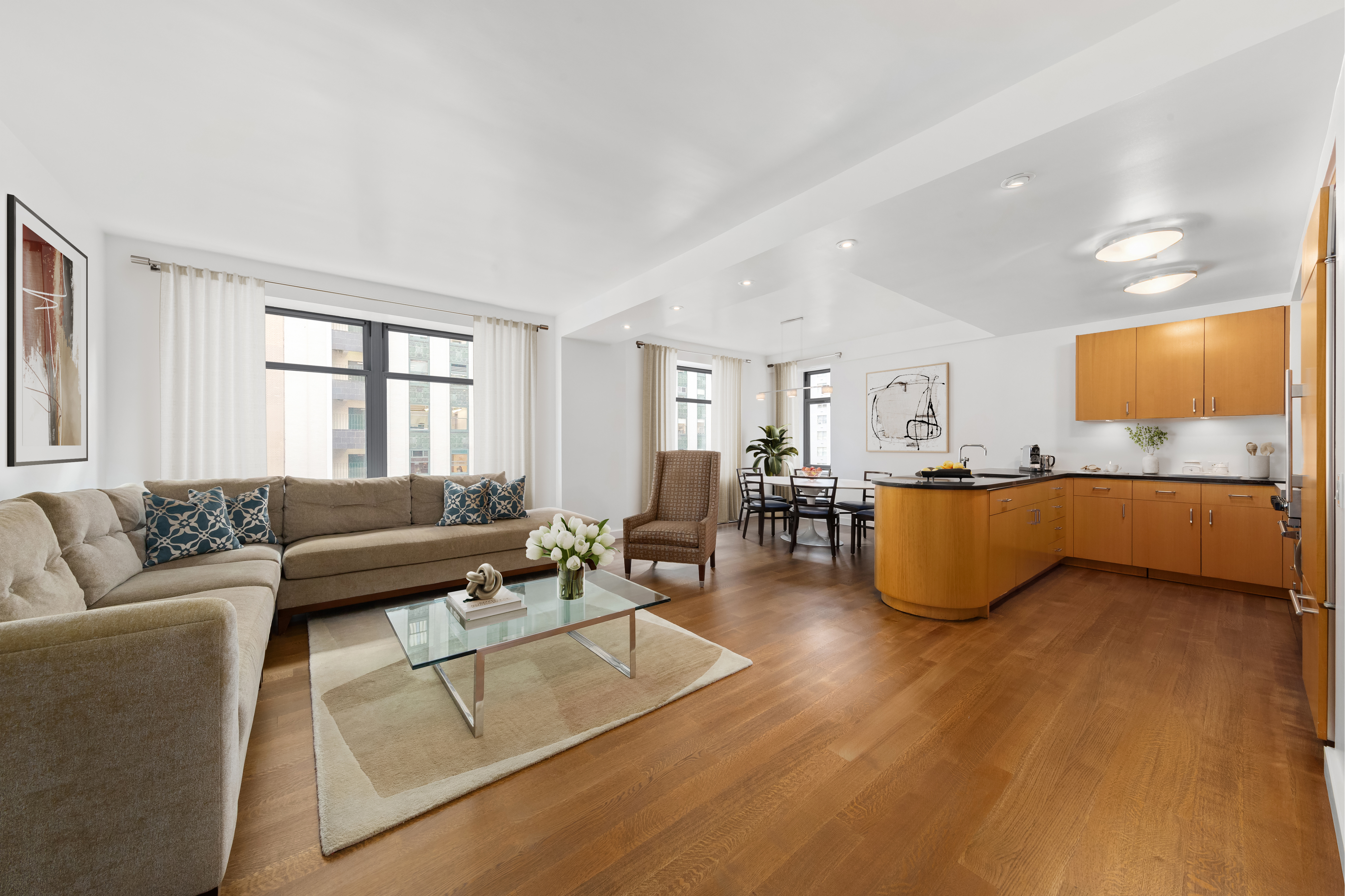 a living room with furniture and kitchen view
