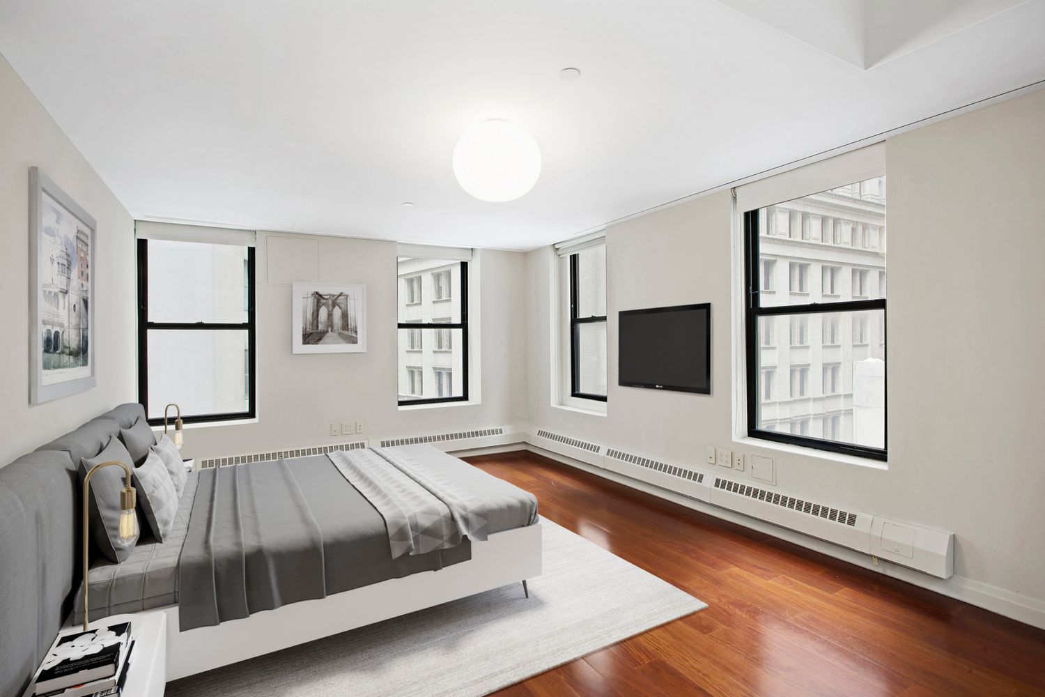 55 Wall Street, Unit PH910 Manhattan, NY 10005 - Photo 7 of 11 a spacious bedroom with a large bed and a window