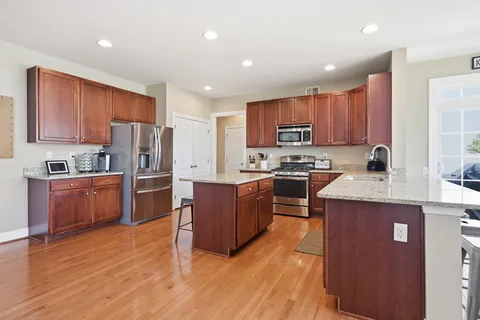 a large kitchen with lots of counter space dining table and chairs