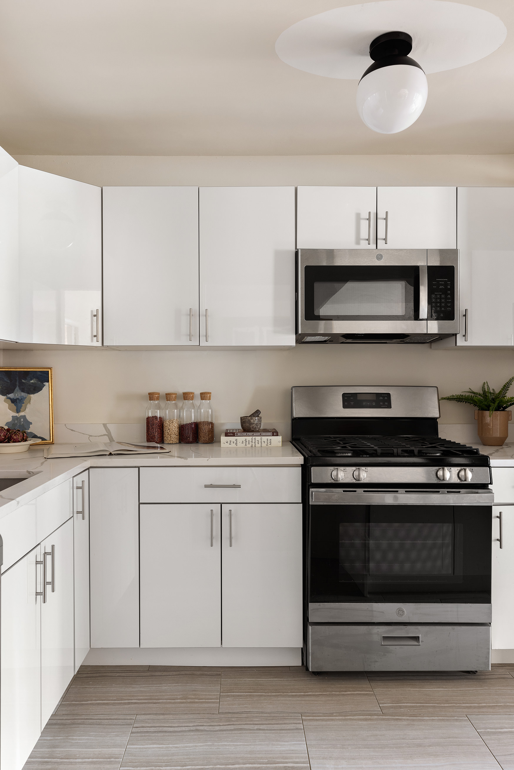 345 East 73rd Street, Unit 9H Manhattan, NY 10021 - Photo 5 of 13 a kitchen with cabinets stainless steel appliances and a sink