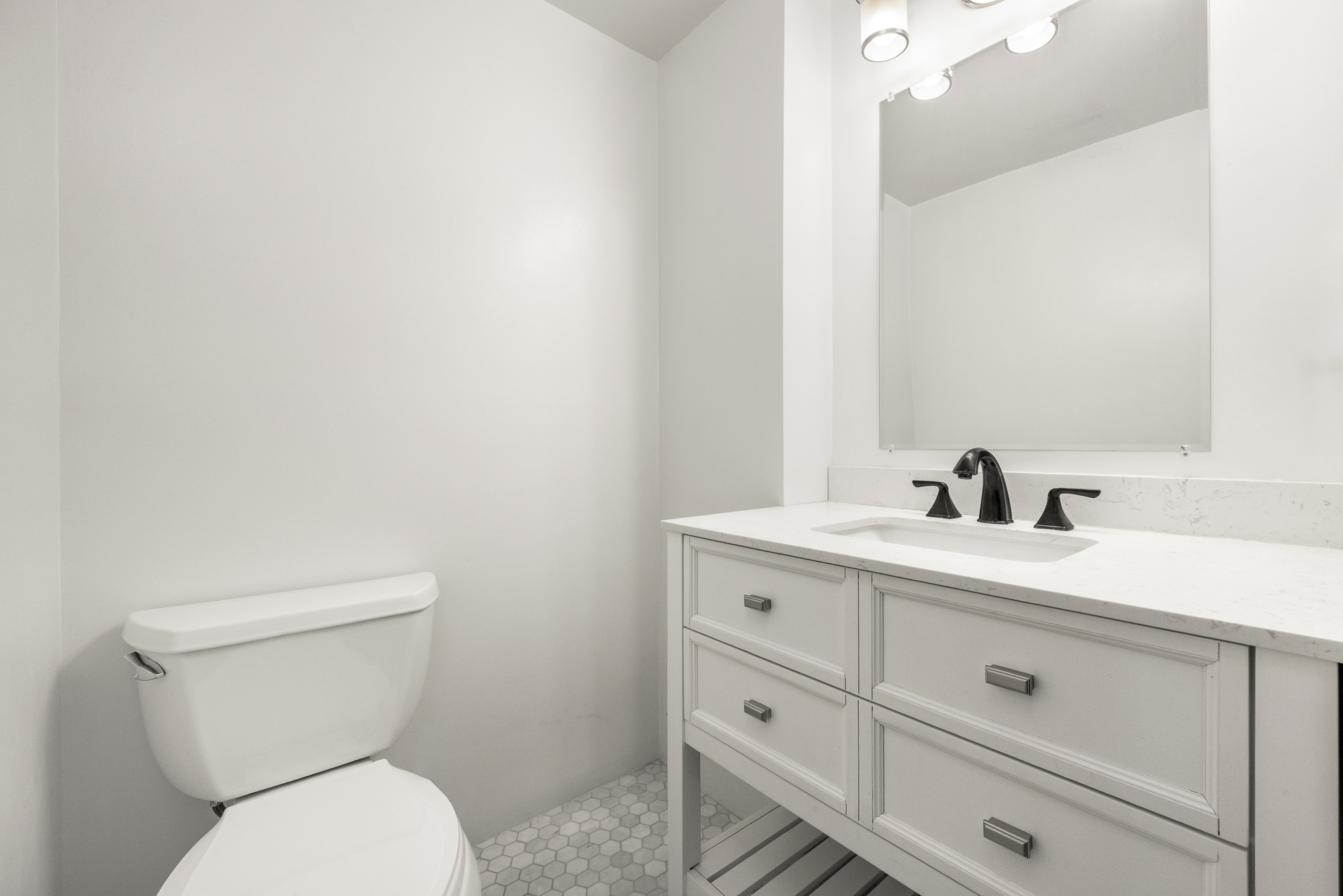 160 West 11th Street, Unit 1 Manhattan, NY 10011 - Photo 17 of 18 a bathroom with a toilet sink and mirror