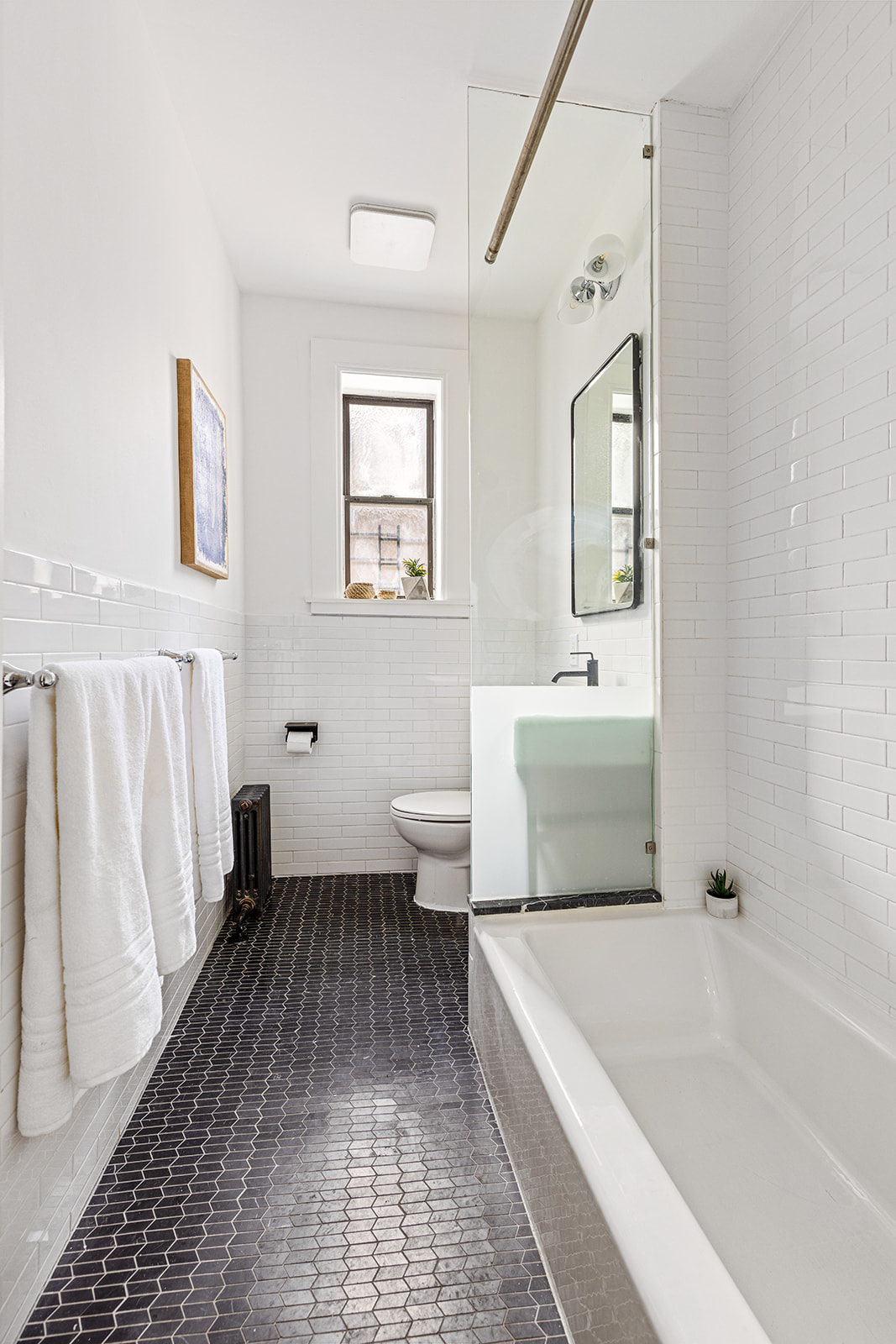 610 Marlborough Road Brooklyn, NY 11226 - Photo 9 of 16 a bathroom with a sink a toilet and a bathtub