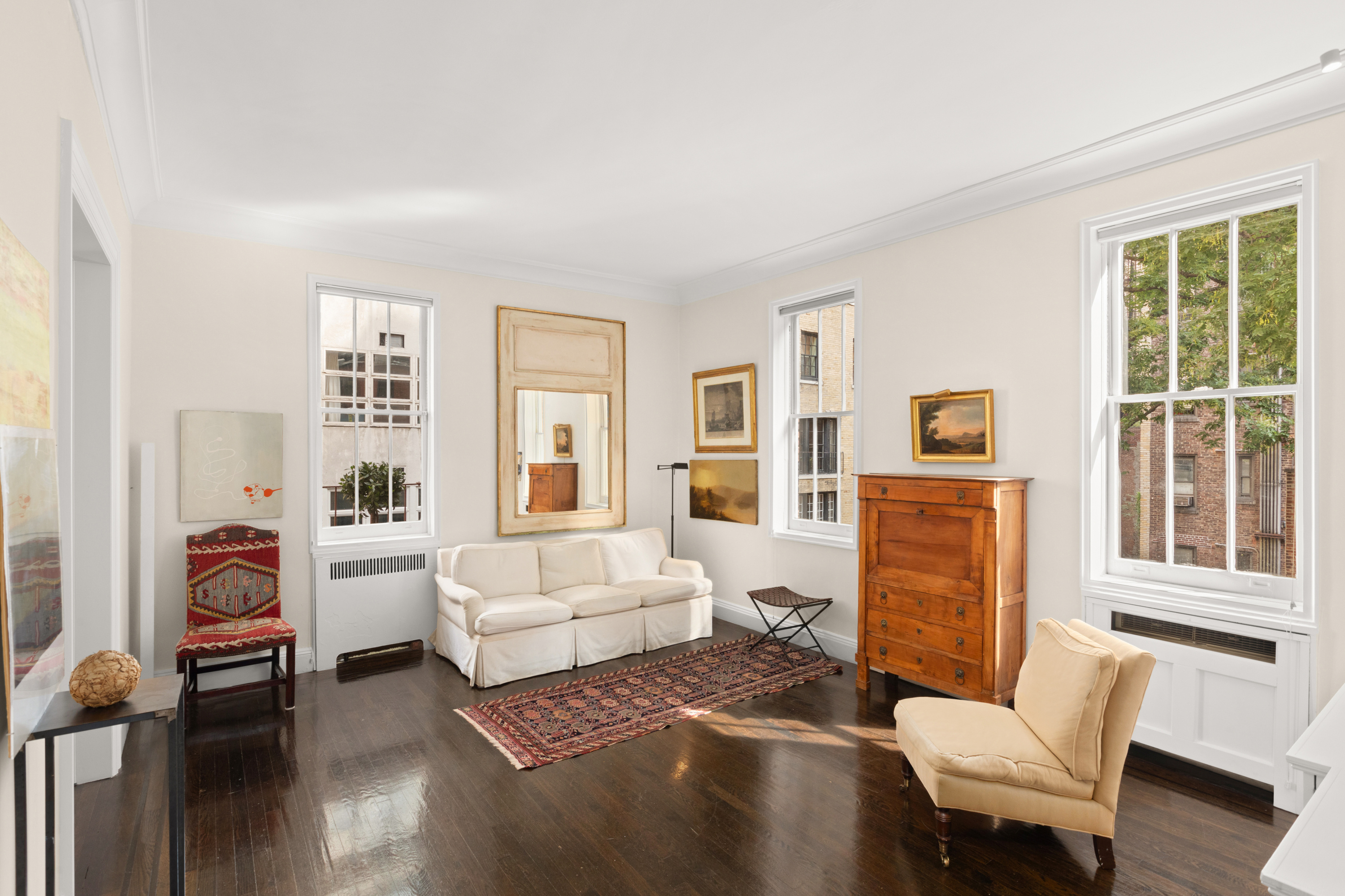 51 East 78th Street, Unit 3BC Manhattan, NY 10075 - Photo 4 of 25 a living room with furniture and a window