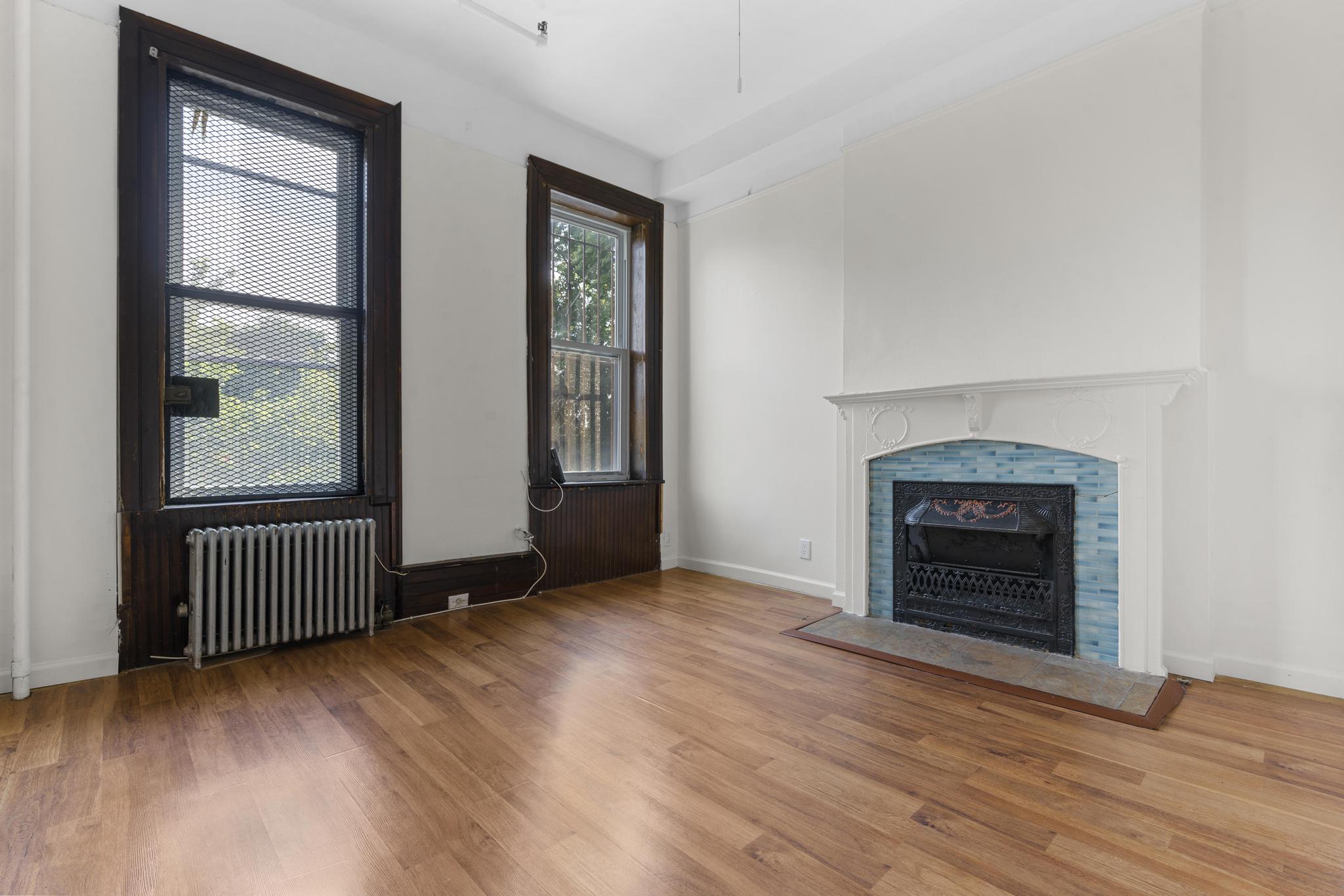 880 Park Place, Unit 2 Brooklyn, NY 11216 - Photo 8 of 12 an empty room with wooden floor fireplace and windows