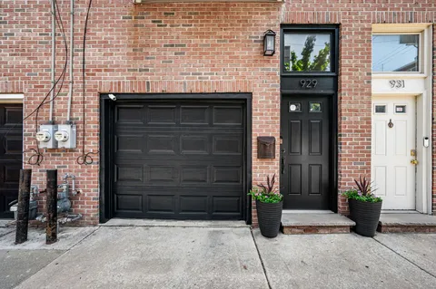 a front view of a house with potted plants