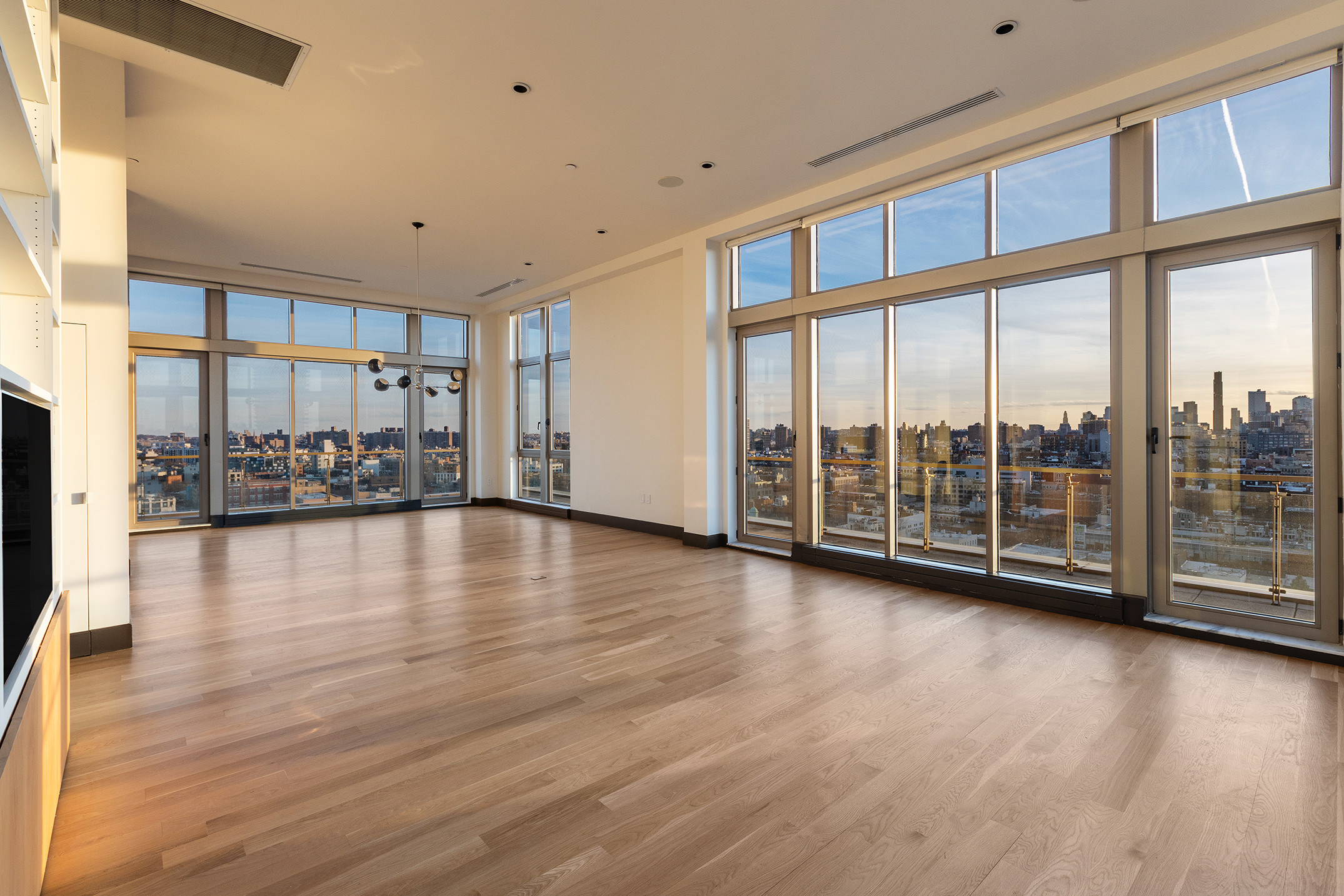 144 North 8th Street, Unit PH2 Brooklyn, NY 11249 - Photo 15 of 20 a view of empty room with wooden floor and floor to ceiling window