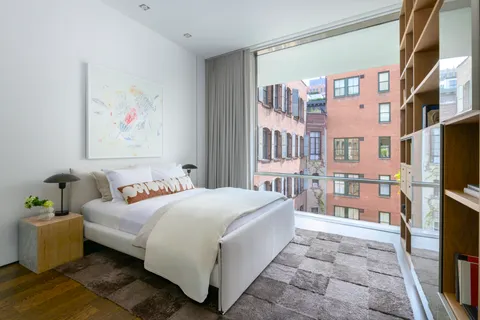 a bedroom with a bed furniture and a flat screen tv