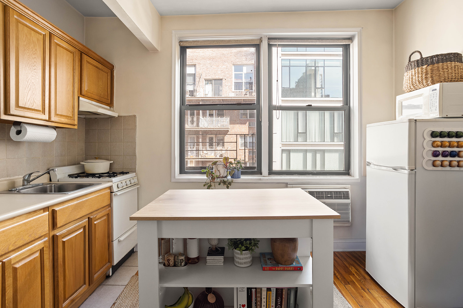 148 East 84th Street, Unit 4A Manhattan, NY 10028 - Photo 2 of 6 a kitchen with a sink cabinets and window