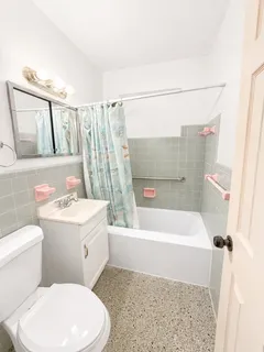 a bathroom with a sink a toilet and bathtub