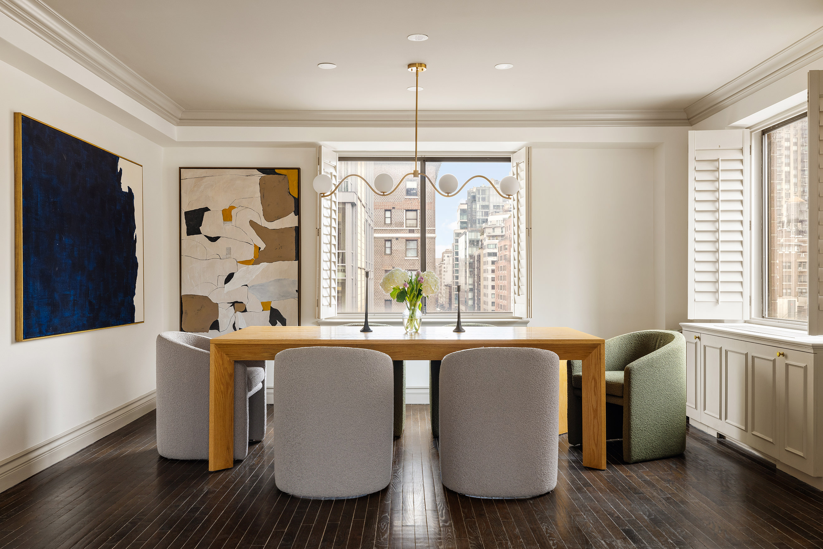 131 East 81st Street, Unit 9 Manhattan, NY 10028 - Photo 4 of 10 a living room with furniture a large window and wooden floor