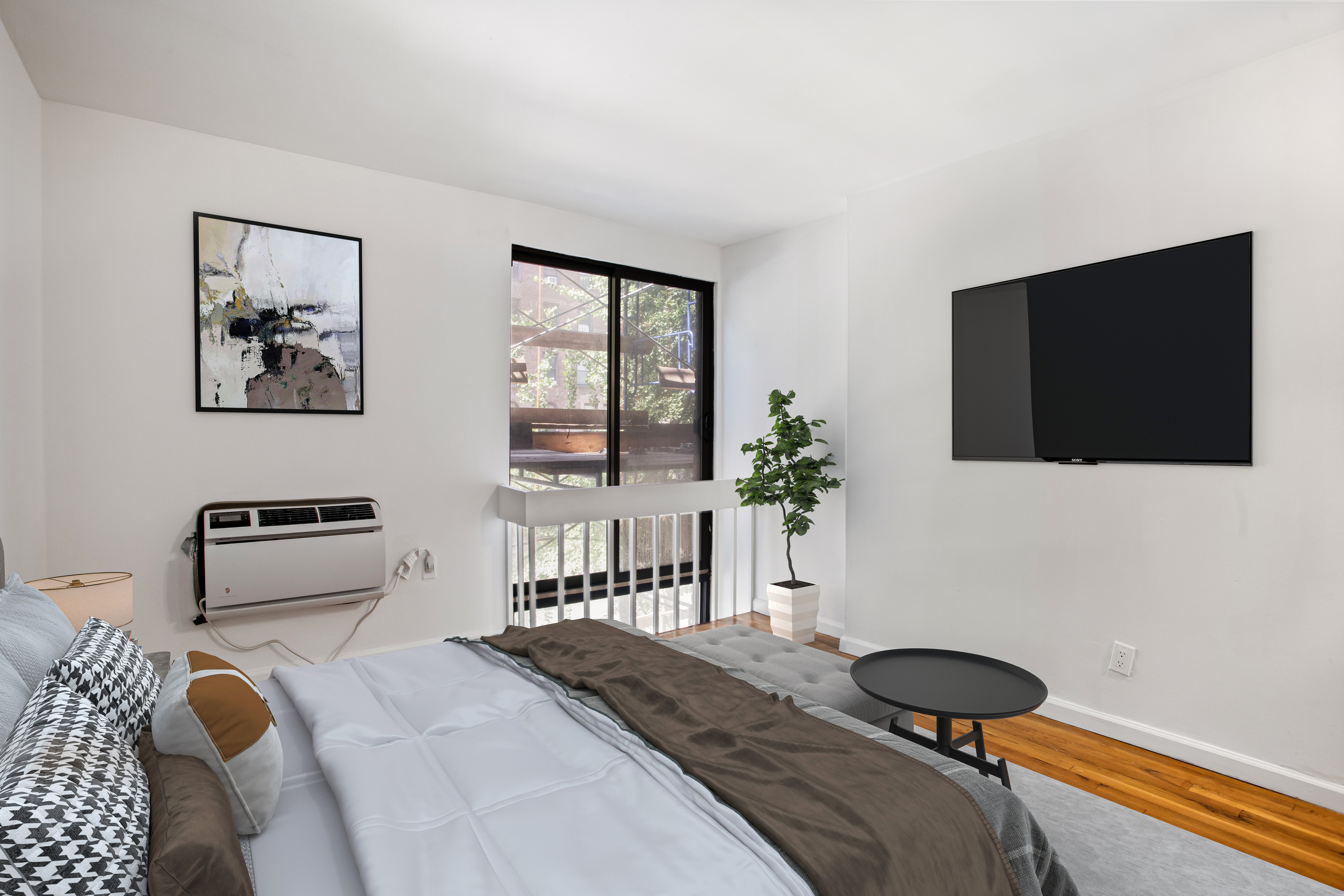 435 East 86th Street, Unit 2C Manhattan, NY 10028 - Photo 5 of 10 a bedroom with a bed and a flat screen tv