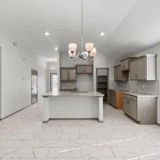 a large kitchen with stainless steel appliances kitchen island granite countertop a sink a stove and cabinets