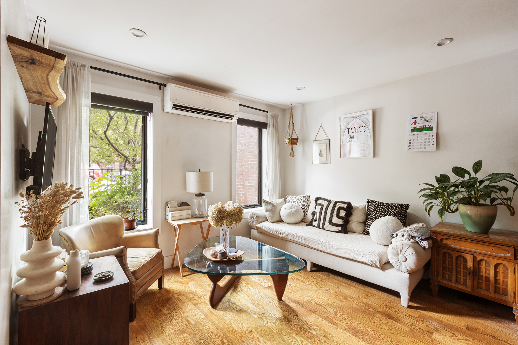 237 Macon Street, Unit 1 Brooklyn, NY 11216 - Photo 2 of 9 a living room with furniture and a flat screen tv