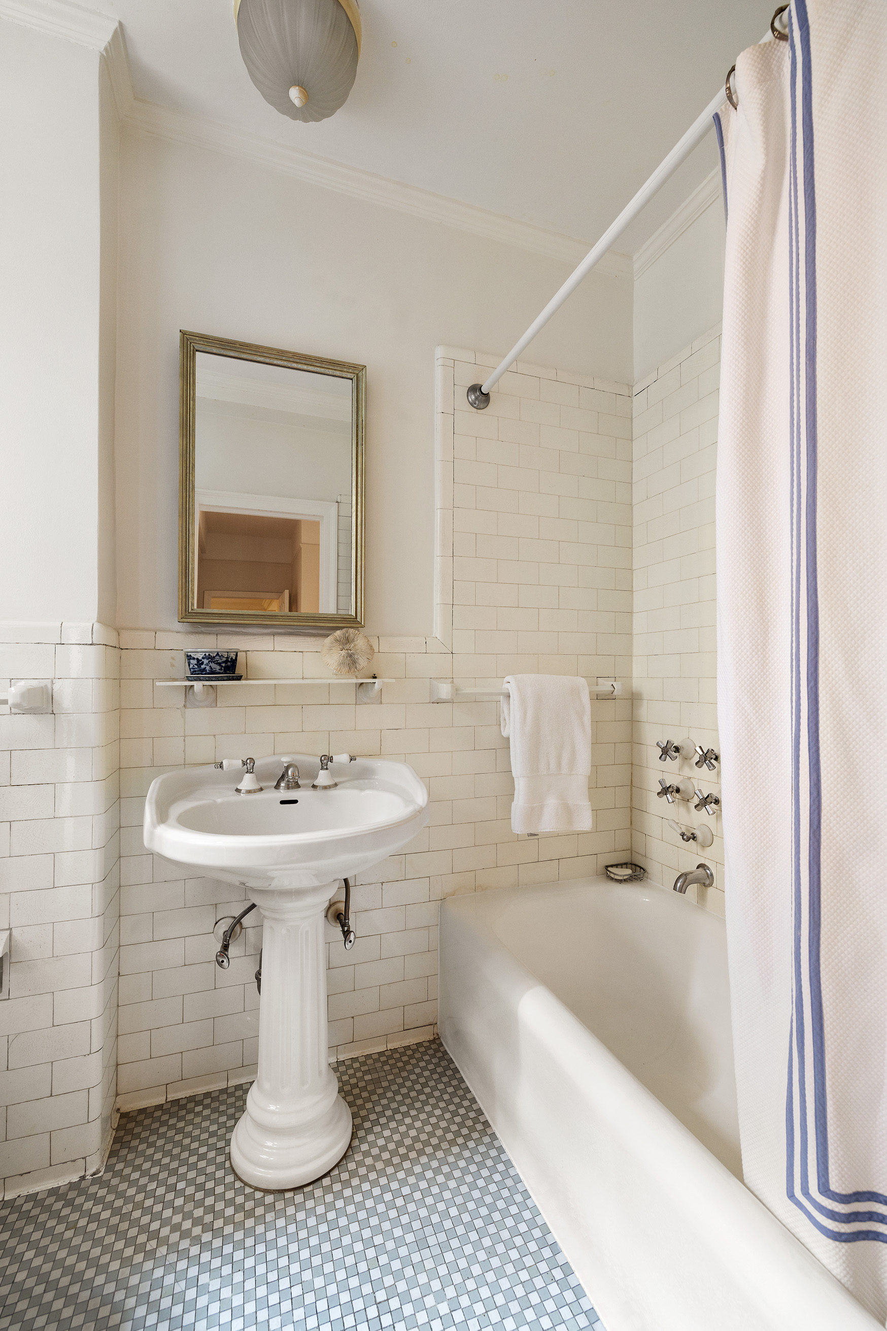 277 West End Avenue, Unit 5D Manhattan, NY 10023 - Photo 11 of 15 a bathroom with a sink a mirror and bathtub