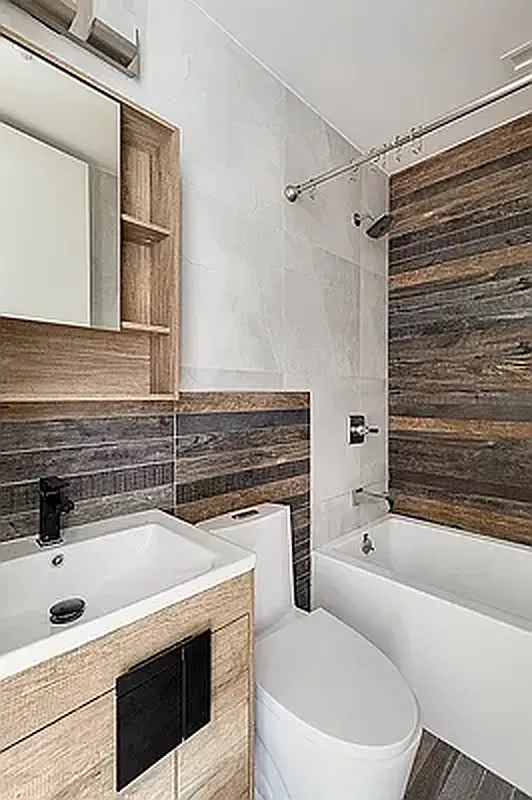 212 Malcolm X Boulevard, Unit 4B Brooklyn, NY 11221 - Photo 5 of 5 a bathroom with a sink a toilet and shower