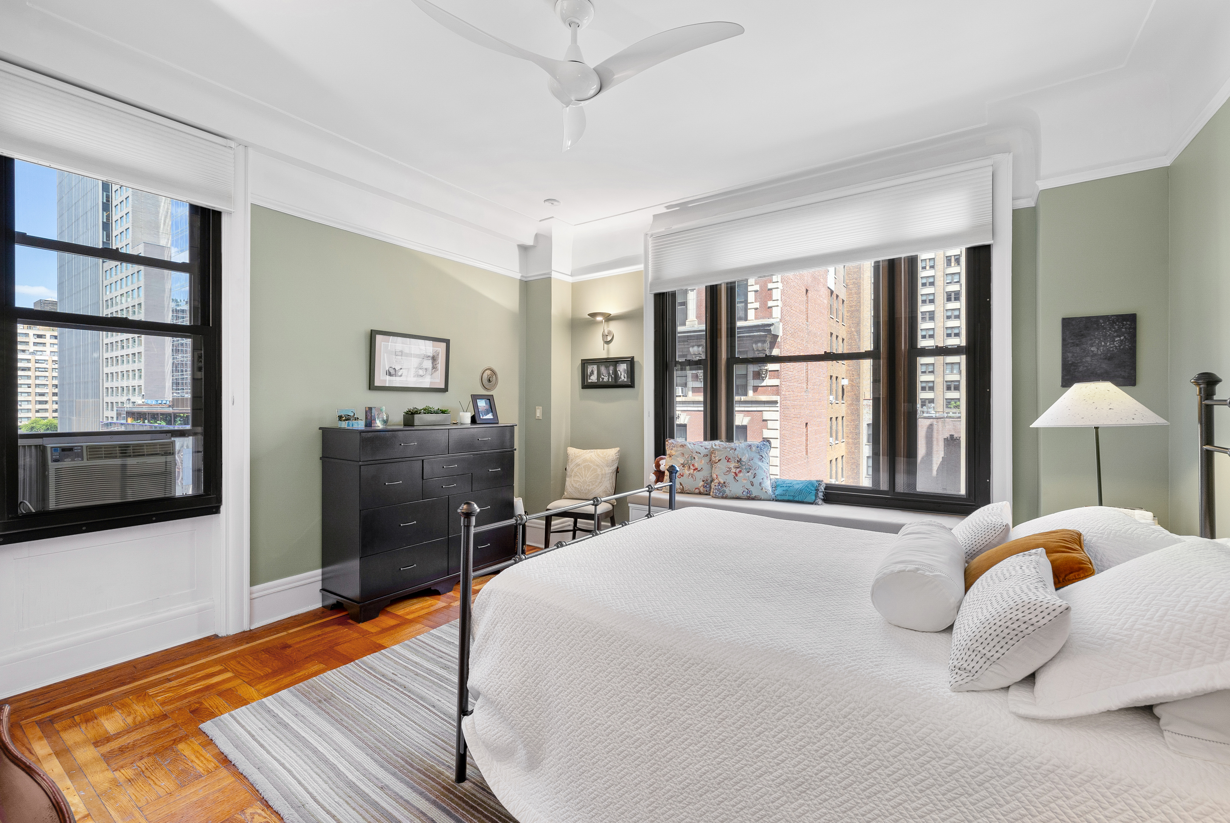 200 West 54th Street, Unit 9G Manhattan, NY 10019 - Photo 9 of 17 a bedroom with a bed and wooden floor