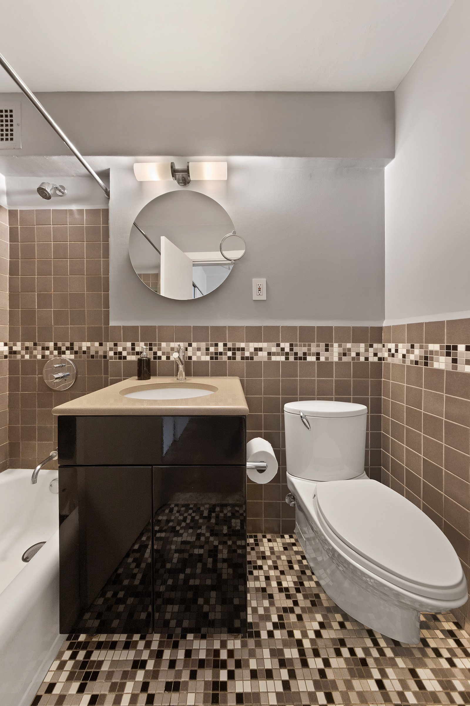 31 Jane Street, Unit 2CD Manhattan, NY 10014 - Photo 12 of 18 a bathroom with a sink a toilet and a mirror