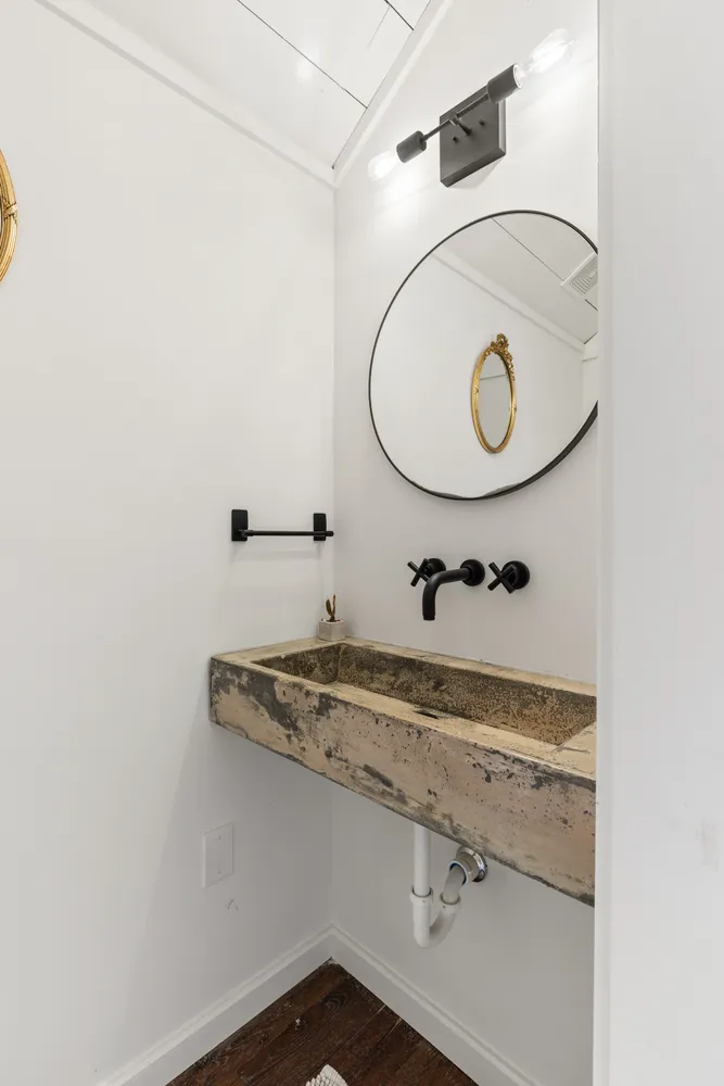 a bathroom with a sink and mirror