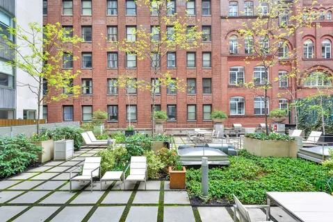 a view of a building with garden and sitting area