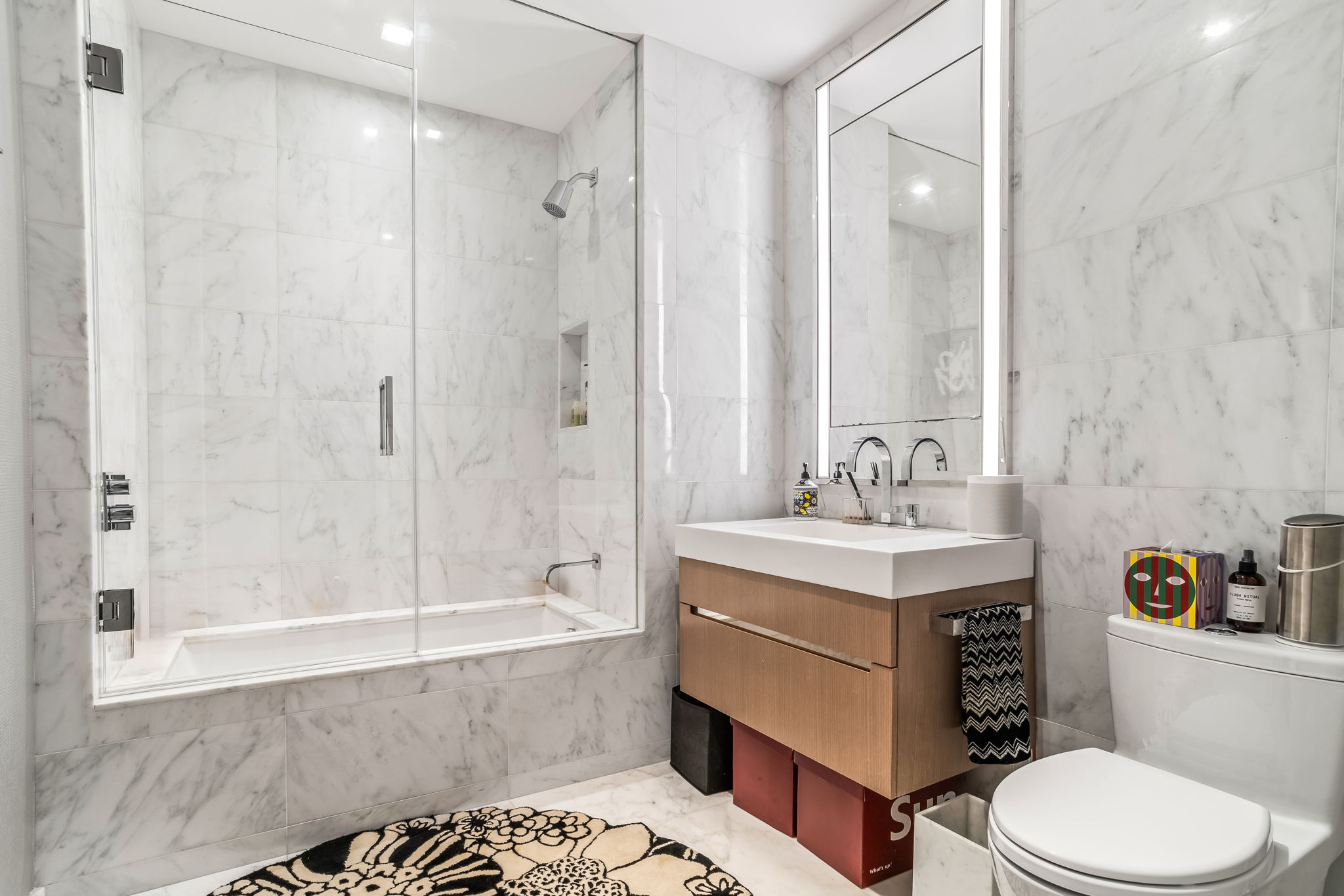 1 West End Avenue, Unit 9D Manhattan, NY 10023 - Photo 14 of 22 a bathroom with a sink a toilet and shower