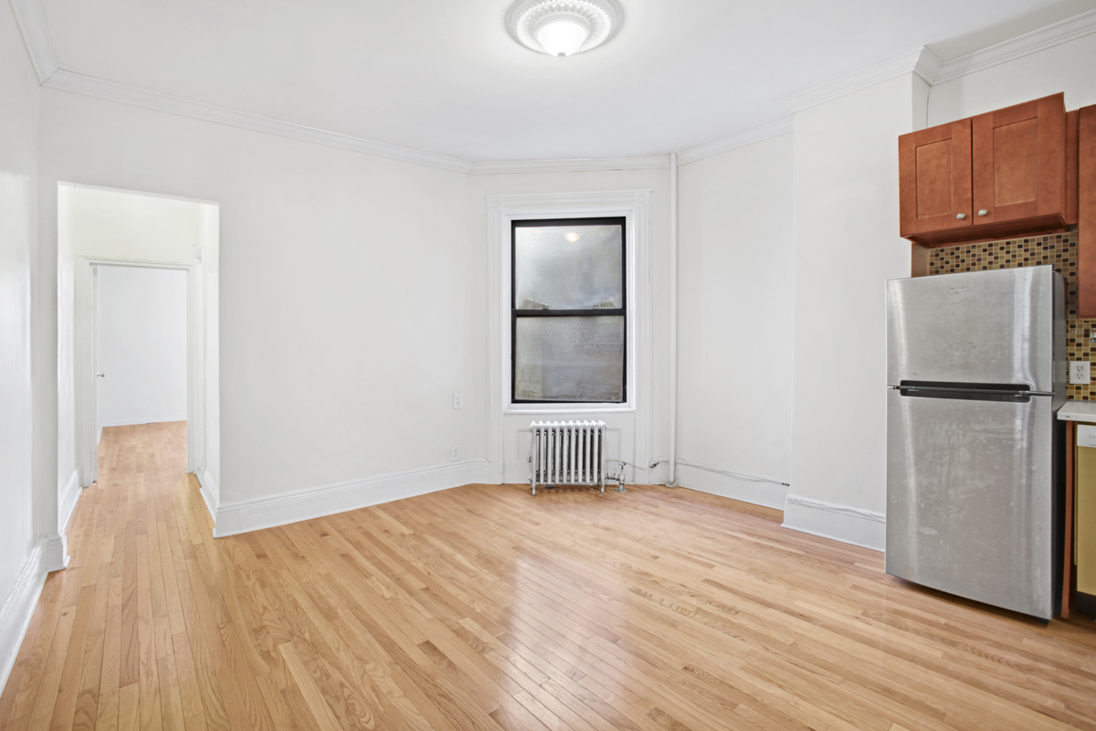 155 Garfield Place, Unit 3B Brooklyn, NY 11215 - Photo 2 of 6 a view of empty room with wooden floor and window
