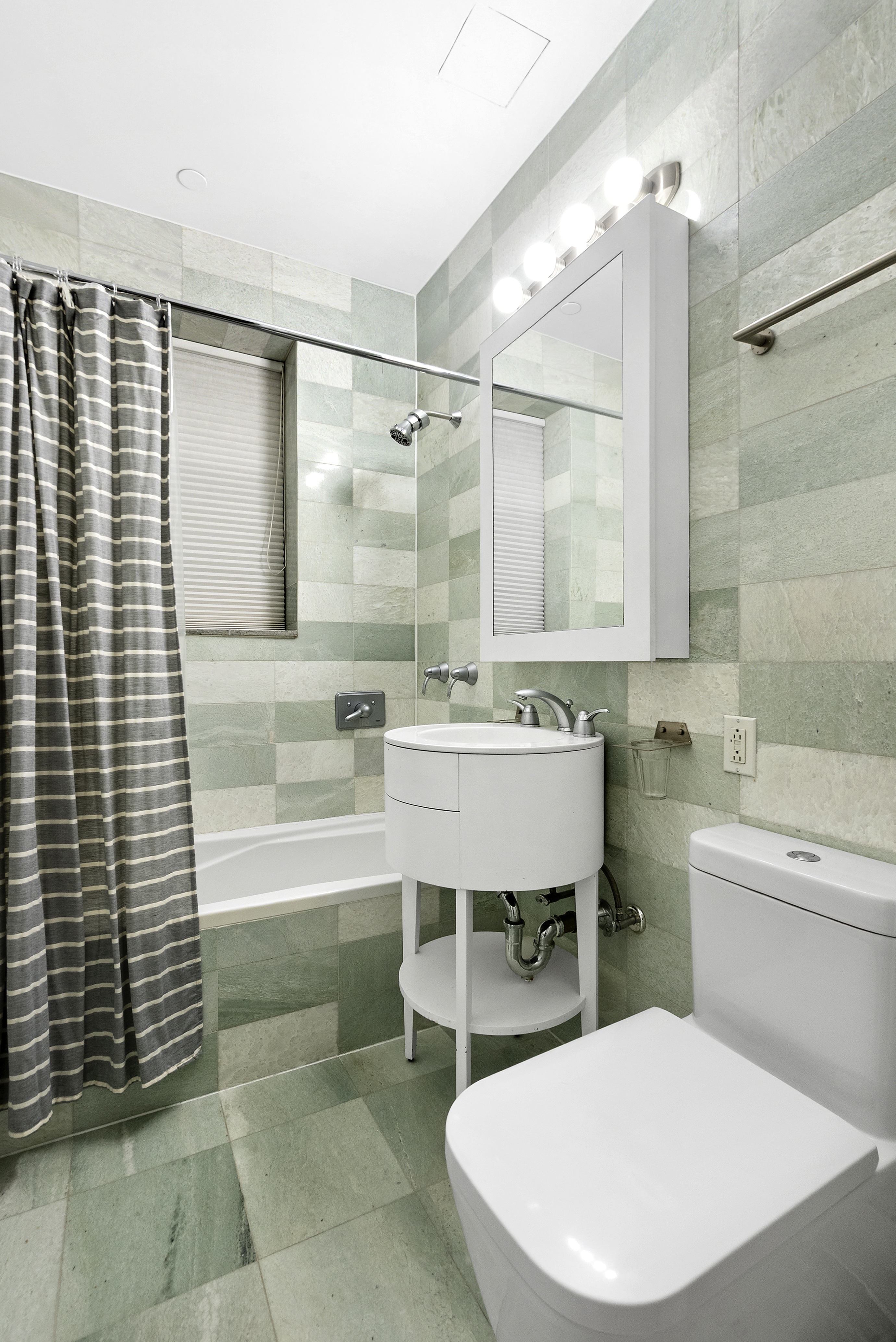 223 West 80th Street, Unit 7 Manhattan, NY 10024 - Photo 9 of 15 a bathroom with a sink a toilet a mirror and bathtub