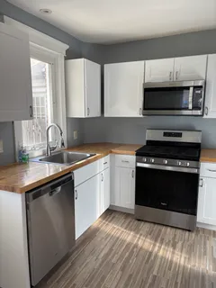 a kitchen with a sink stove and microwave