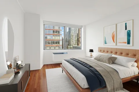 a bedroom with bed and a window