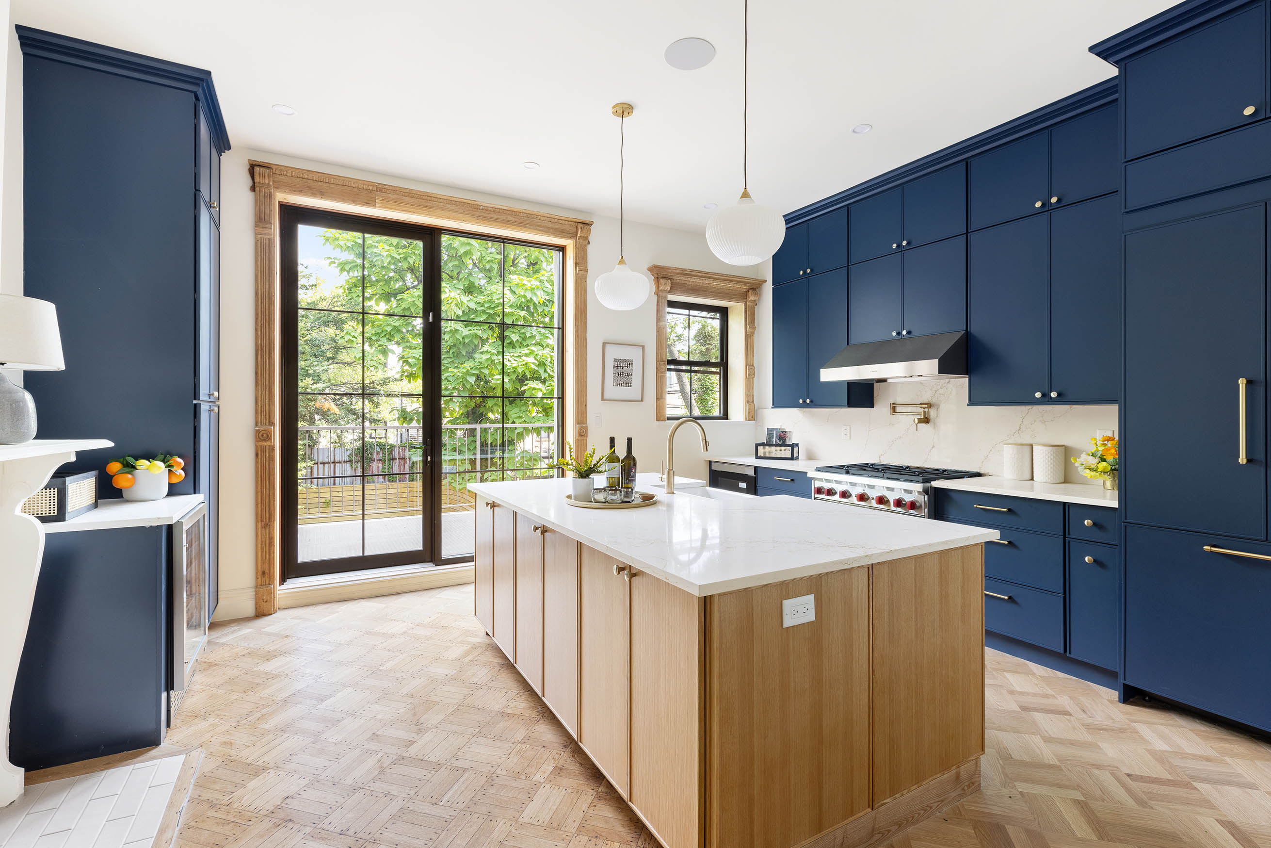 647 Macon Street Brooklyn, NY 11233 - Photo 8 of 20 a kitchen with kitchen island a sink a stove and a refrigerator with wooden floor