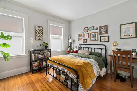 a living room with stainless steel appliances granite countertop a stove top oven a sink dishwasher a dining table and chairs with wooden floor