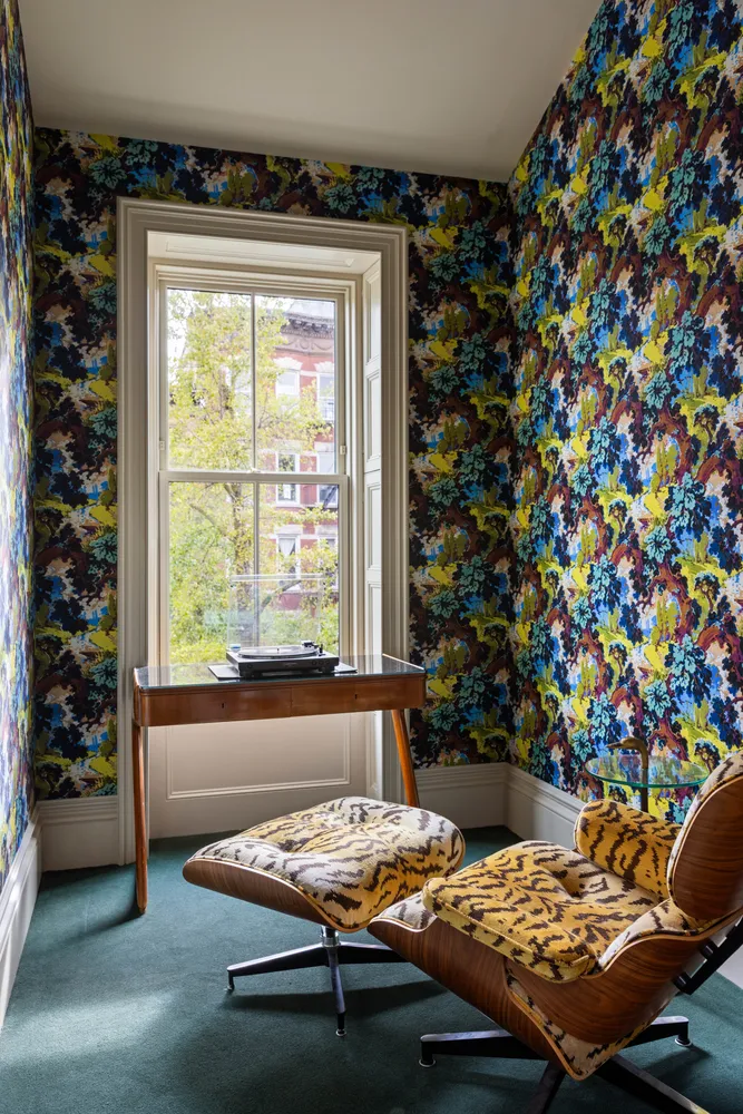 a bedroom with a bed a rug and chair