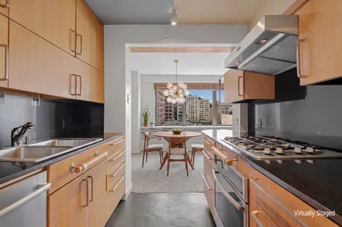 a kitchen with stainless steel appliances a stove a sink and a microwave