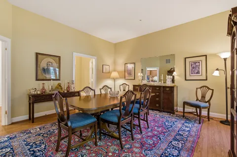 a spacious bathroom with a granite countertop sink a toilet and a mirror