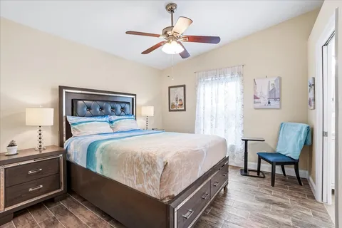 a bedroom with a bed and a chandelier