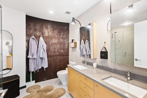 a bathroom with a sink double vanity and a shower