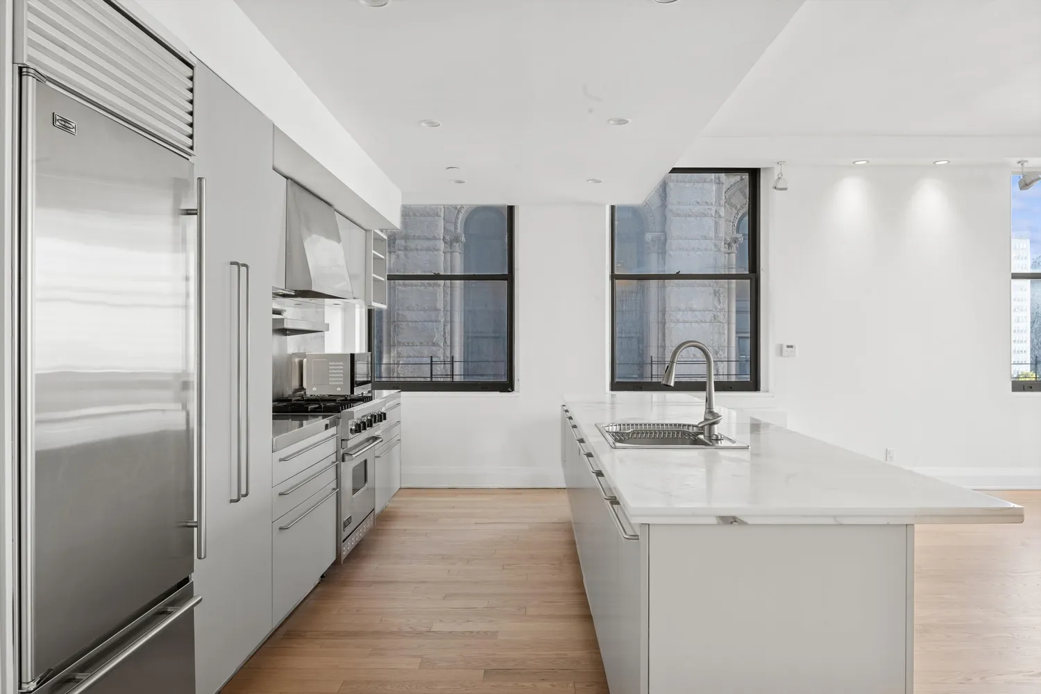 a kitchen with white cabinets and stainless steel appliances