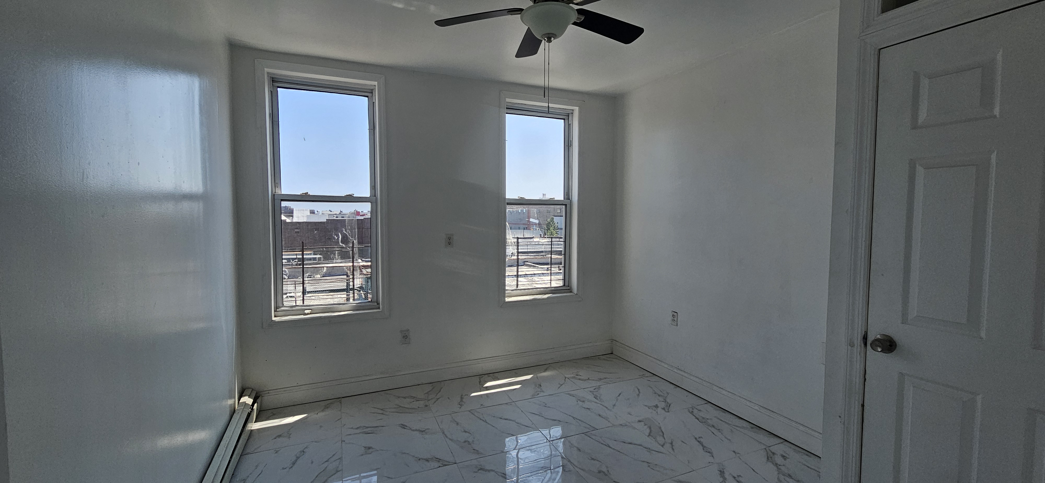 2610 Atlantic Avenue, Unit 3 Brooklyn, NY 11207 - Photo 4 of 5 an empty room with windows and closet