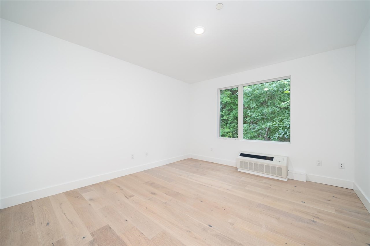 8621 River Road, Unit 6D North Bergen, NJ 07047 - Photo 11 of 36 an empty room with wooden floor and windows