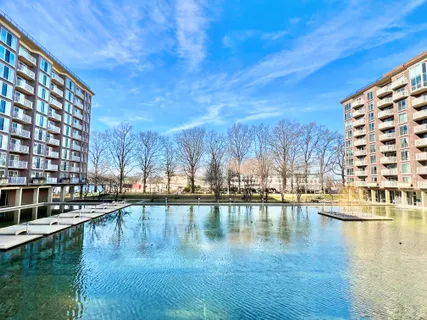 a swimming pool that has lawn chairs